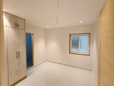 First bedroom of the Elite Homes 3 BHK sample flat with wardrobe and passage door