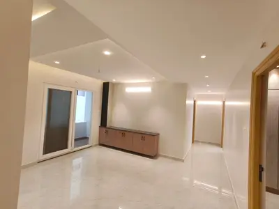 Dining area of the Elite Homes 3 BHK sample flat with sliding door to the balcony and a sideboard