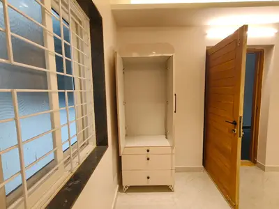Puja niche of the Elite Homes 3 BHK sample flat beside the main door, with a built-in unit